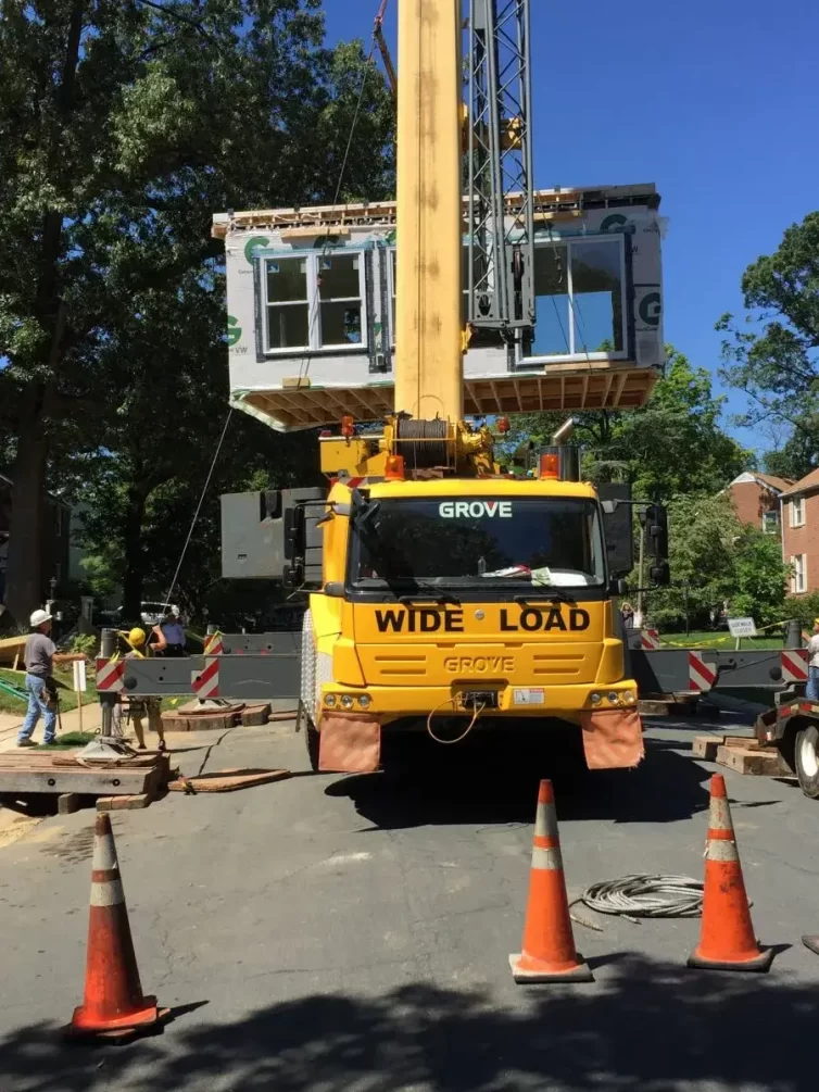 Modular addition being moved by crane